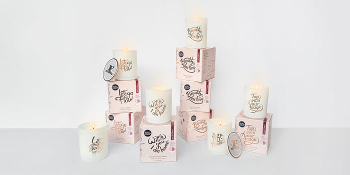 All of the Secret Fortune Candles shown with their packaging.
